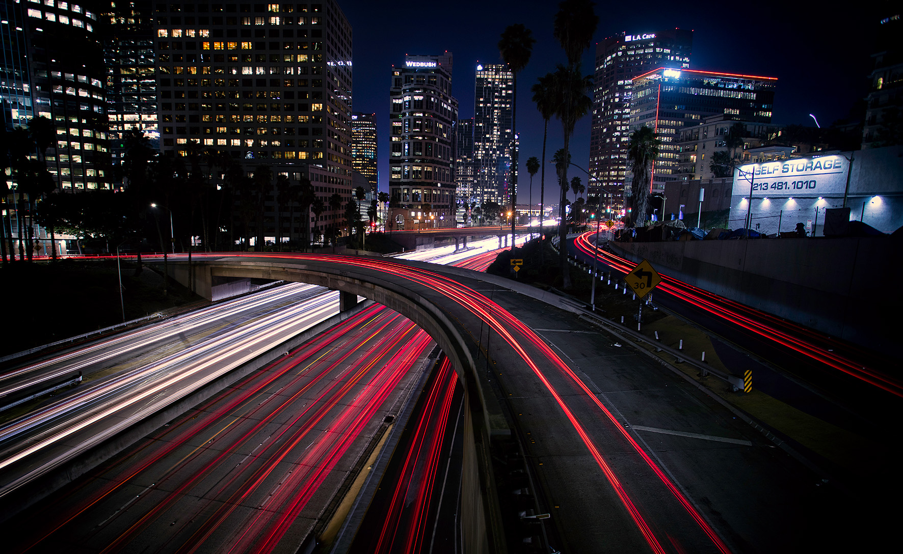 high-angle-view-illuminated-street-amidst-buildings-night.jpg