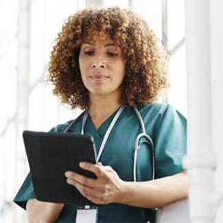 A healthcare worker checks a tablet PC