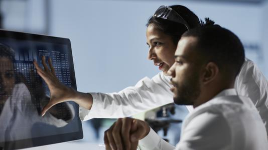 Scientists Working on Computer In Modern Laboratory 