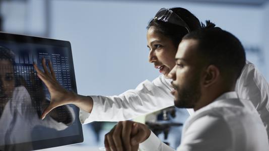 Scientists Working on Computer In Modern Laboratory 