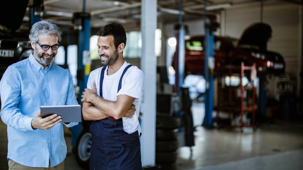 Two workers talking in a factory