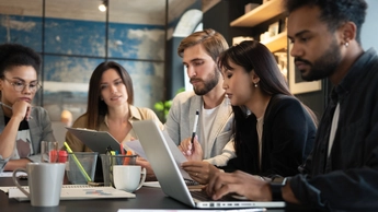 Group of young multiracial people working in modern office. Businessmen at work during meeting.