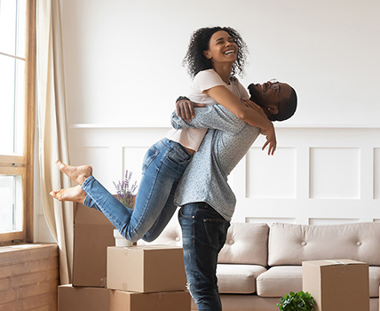 Happy couple hugging in home