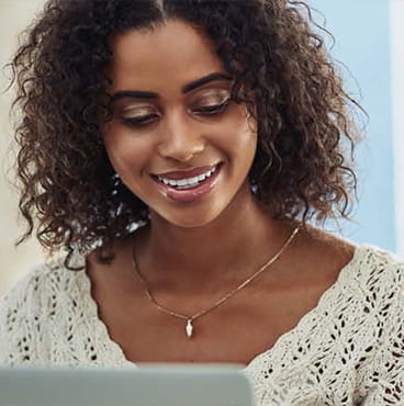 woman working on laptop and smiling