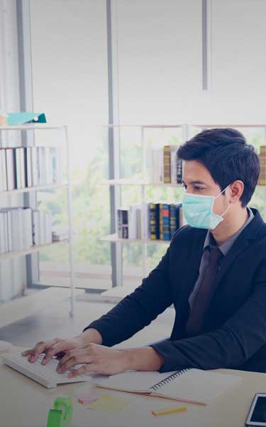 employees wearing masks working in an office setting