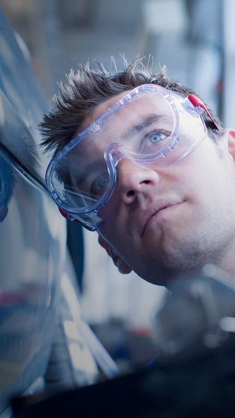 man wears safety goggles