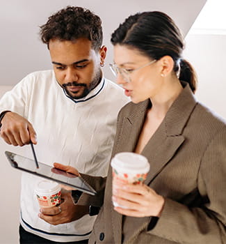 Man Pointing To A Pc Tablet That A Woman Holds