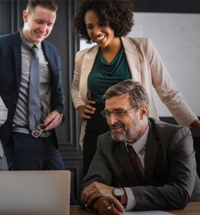 colleagues in a meeting with a couple of them standing behind