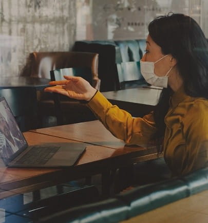 woman wearing mark and in virtual meeting