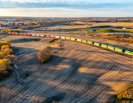 train running through wide open field