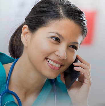 female nurse smiling and talking on phone