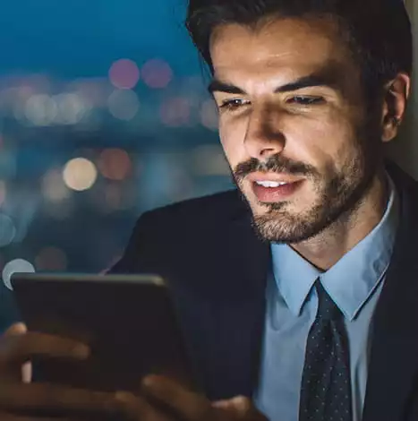 man using tablet at night