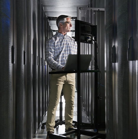 men controlling datacenter through laptop