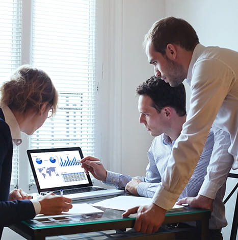 men showing company progress charts to his team