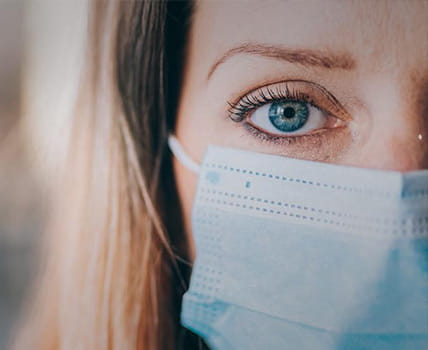 woman wearing protective face mask in the office