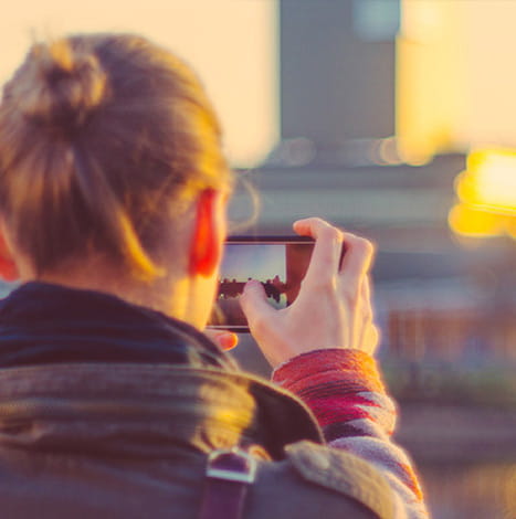 women clicking picture in mobile