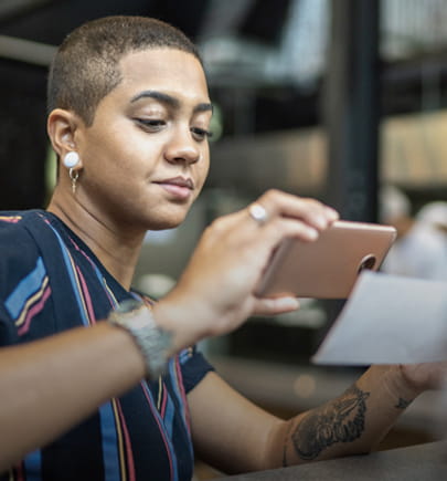 woman taking picture of check for online banking