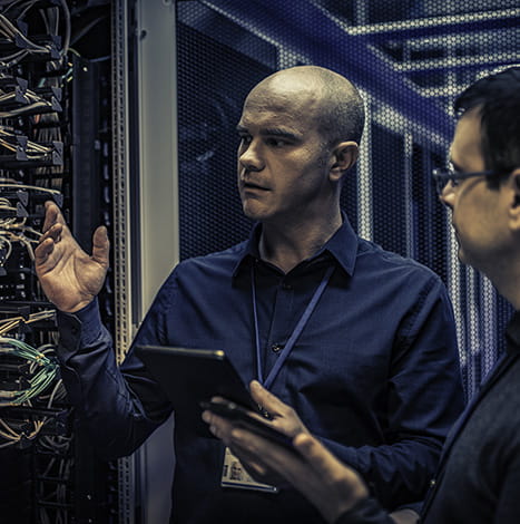 two mens checing the cables in data center