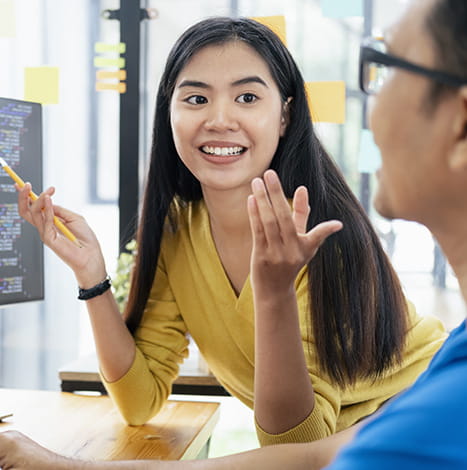 womens smiles and looking at his teammate having pencil in hand