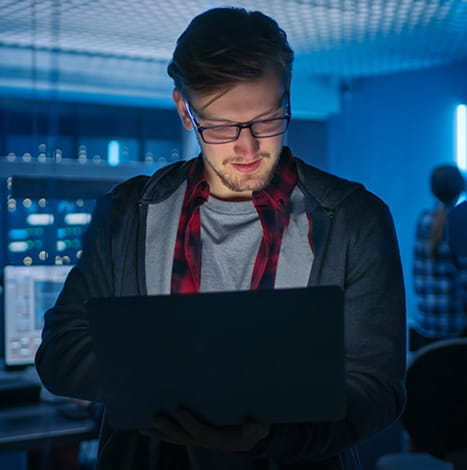 standing men working on laptop