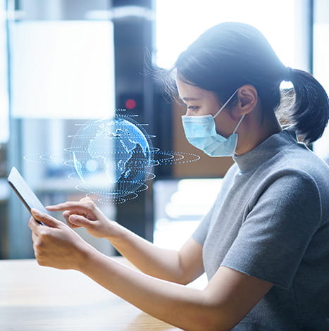 women with mask clicking on the tablet in the digital world