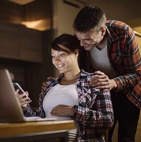 men supporting working women sitting on the chair and both smiles