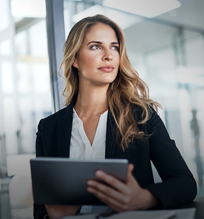 woman in suit holding a tablet