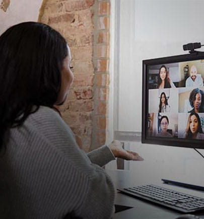 woman working from home with meeting on screen