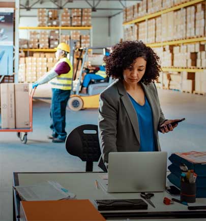 Warehouse Manager using a laptop