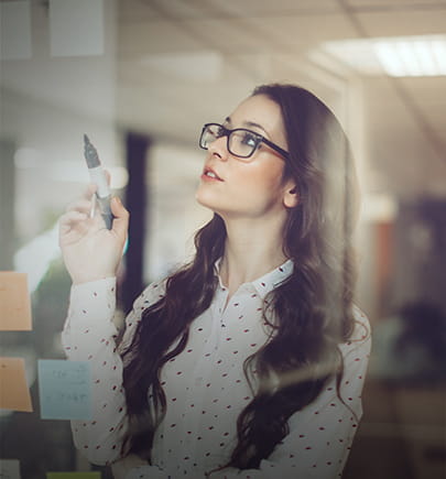 Woman with marker and sticky notes