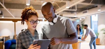 Team of workers looking at a business plan on a tablet