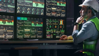 Main engineer following the plant process using Industry 4.0. Operator control process of production uses computer screens with SCADA system