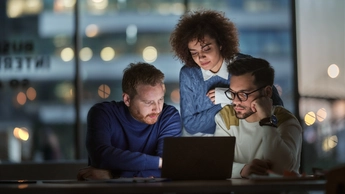 Business team working on a computer late in the office