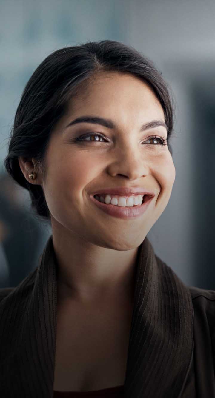 woman with hair pulled back smiling