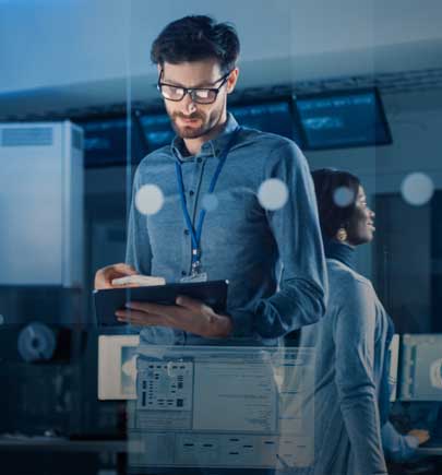 man standing in workspace working on tablet