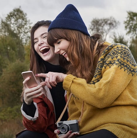 two women looking at cellphone