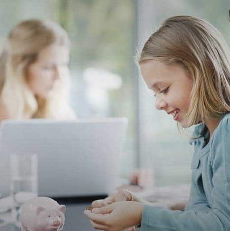 little girl with piggy bank