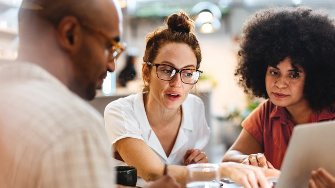 Business women having a discussion with a client over a business lunch