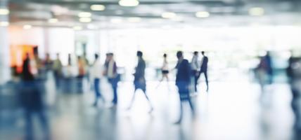 Walking Blurred People in a Bright Large Hall