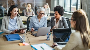 Team of businesswomen working on computers in the office.