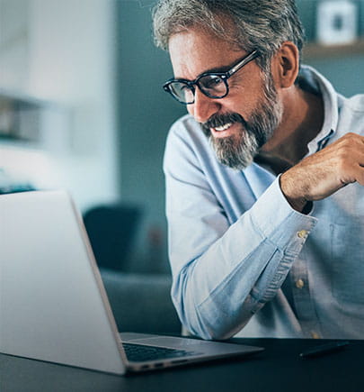 Man happily working on laptop