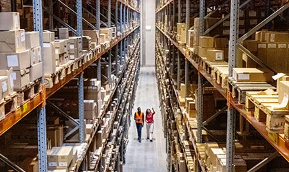 two employees walking through warehouse