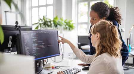 two women looking at computer screen