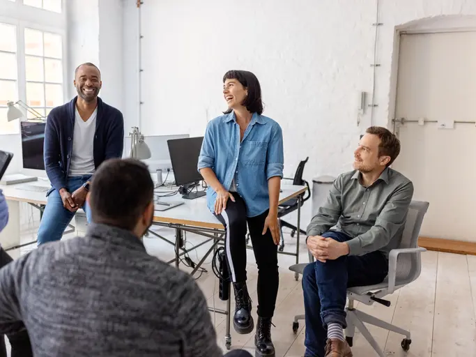 Multiracial businesspeople having a casual conversation at the office after meeting