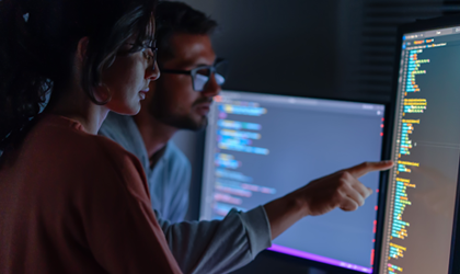 two colleagues reviewing data on screen