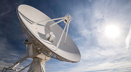 Blue moon sky with television dish antenna