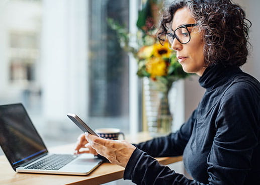 women is working and using phone in her workplace.