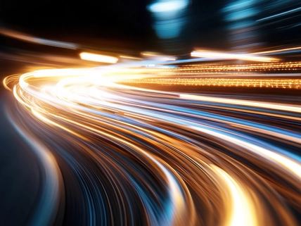 Dynamic streaks of light illuminate the urban nightscape, capturing the energy and movement of a bustling city as vehicles pass by, creating vibrant visual excitement.