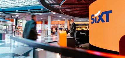 traveler walking up to SIXT desk