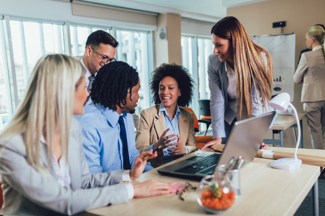  Group of young business people working together in creative office. Selective focus.